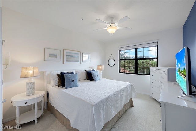 bedroom featuring light carpet and ceiling fan