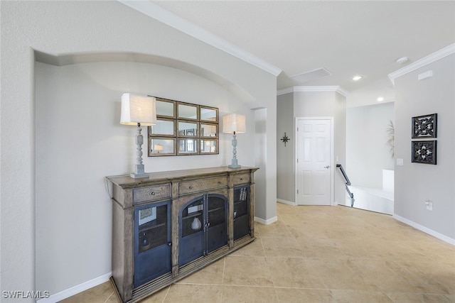 hallway featuring crown molding and light tile patterned flooring