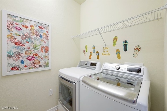 washroom with washing machine and clothes dryer