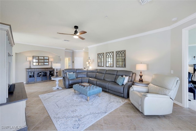 tiled living room with ceiling fan and ornamental molding