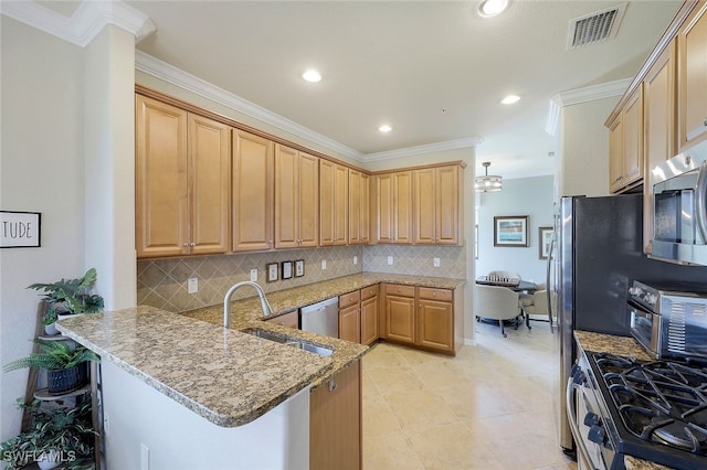 kitchen with light stone counters, stainless steel appliances, a kitchen bar, and kitchen peninsula