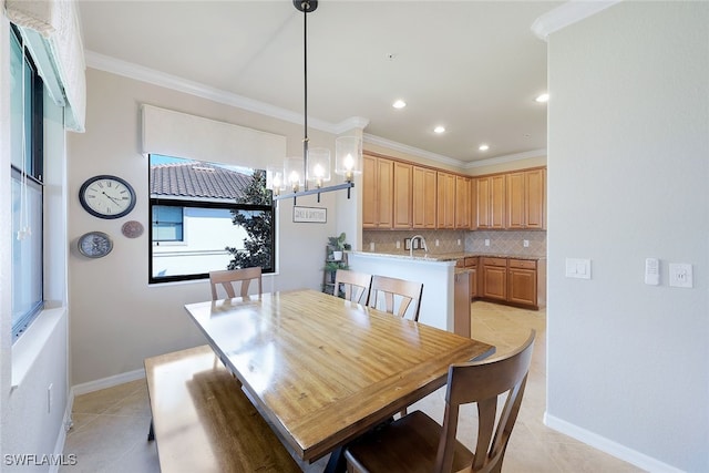 tiled dining area featuring ornamental molding, sink, and an inviting chandelier