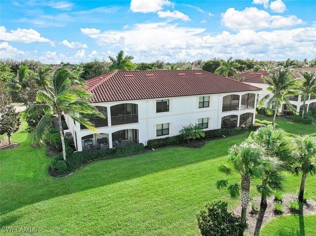 rear view of property with a lawn