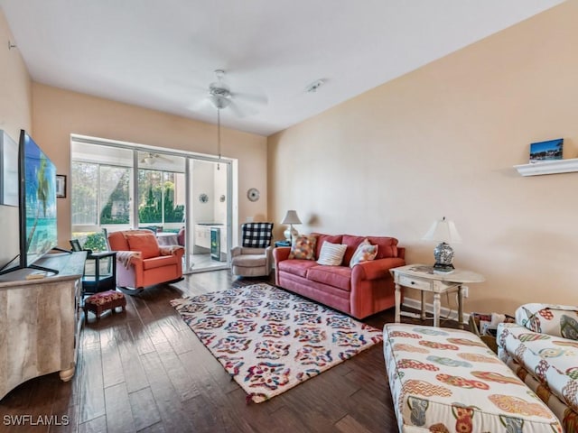 living room with ceiling fan and dark hardwood / wood-style flooring