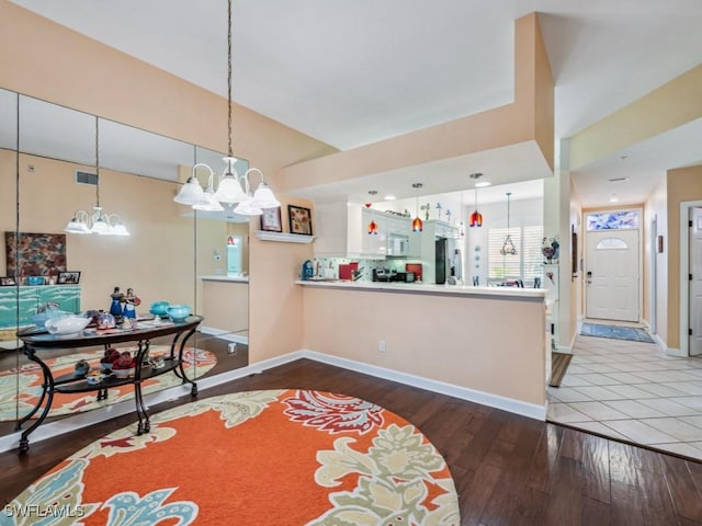 dining space featuring hardwood / wood-style floors and a notable chandelier