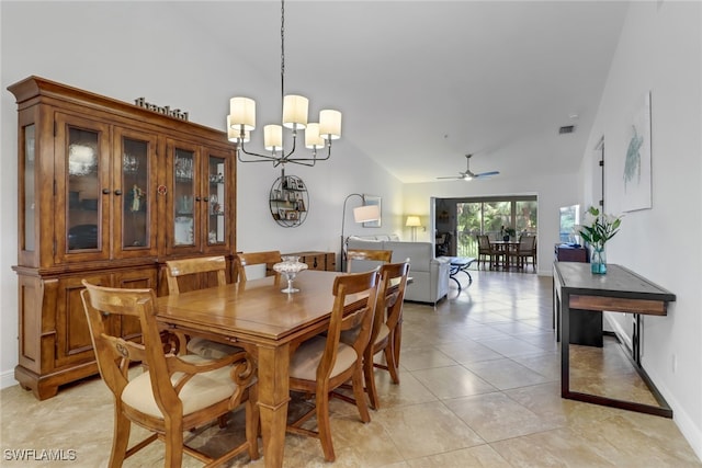 dining area with vaulted ceiling, ceiling fan with notable chandelier, and light tile patterned floors