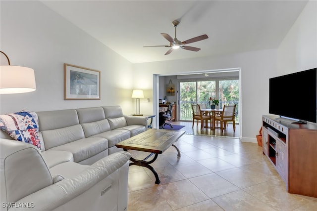 tiled living room with ceiling fan and vaulted ceiling