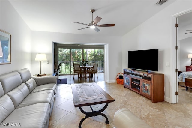 living room with vaulted ceiling, light tile patterned floors, and ceiling fan