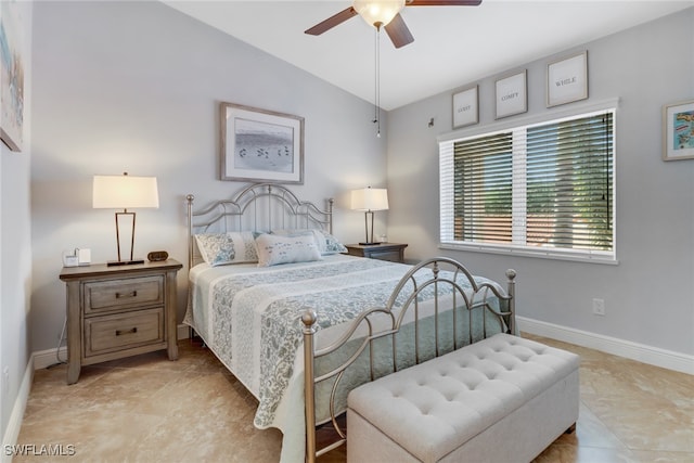 tiled bedroom with ceiling fan and vaulted ceiling