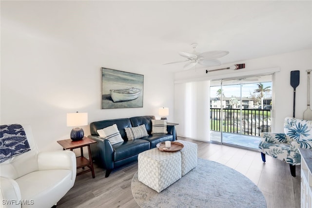 living room with ceiling fan and light wood-type flooring