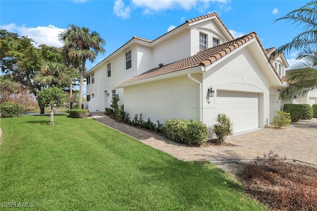 view of property exterior with a yard and a garage