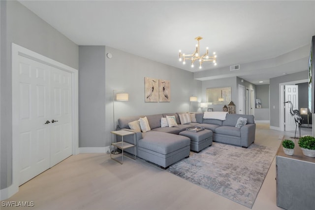 living room with a notable chandelier and light hardwood / wood-style flooring