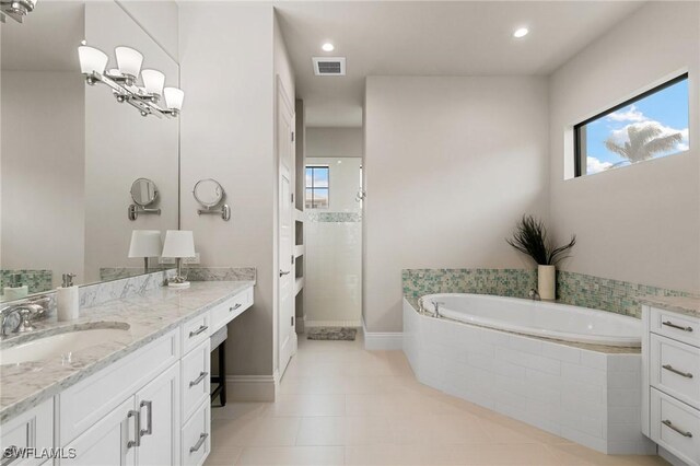 bathroom featuring tile patterned flooring, vanity, and separate shower and tub