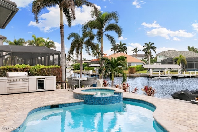 view of pool featuring a patio area, a water view, area for grilling, an in ground hot tub, and a grill