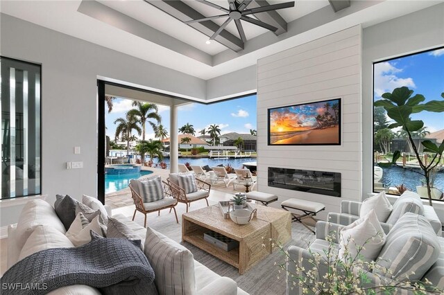 living room featuring a large fireplace and beam ceiling