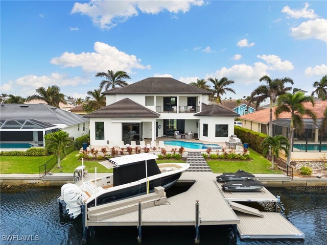 rear view of property featuring a balcony, a water view, and a patio