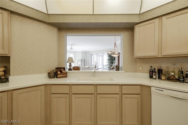 kitchen featuring light brown cabinets, ceiling fan with notable chandelier, white dishwasher, and sink