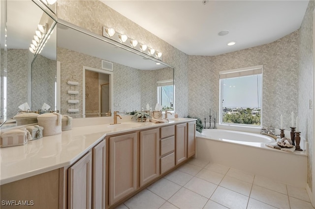 bathroom featuring tile patterned floors, a tub to relax in, and vanity