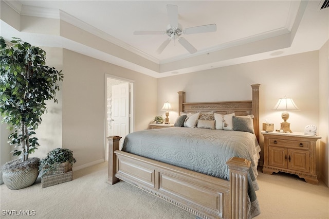 bedroom featuring ornamental molding, ceiling fan, a raised ceiling, and light colored carpet