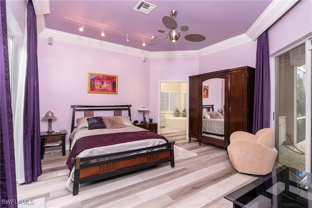 bedroom featuring ensuite bath, light hardwood / wood-style flooring, and ornamental molding