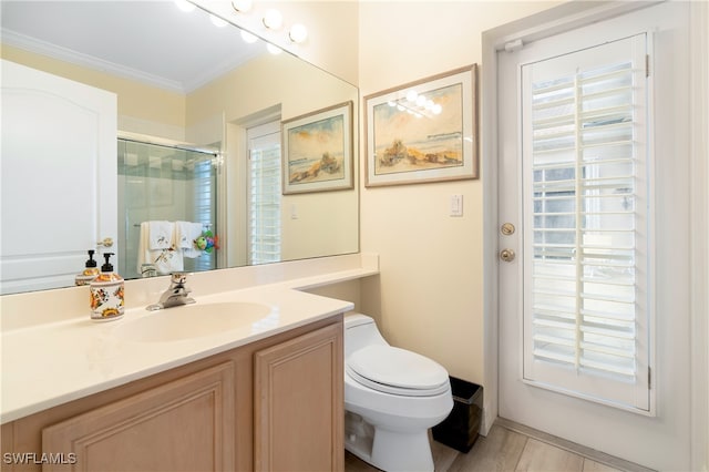 bathroom with toilet, hardwood / wood-style floors, vanity, crown molding, and walk in shower