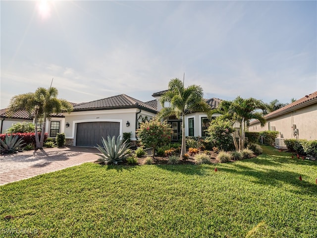 mediterranean / spanish-style house with a front lawn and a garage