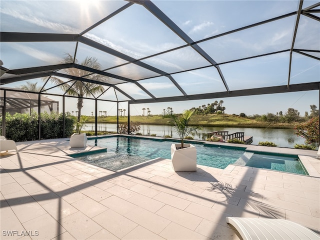 view of pool with a patio, a lanai, and a water view