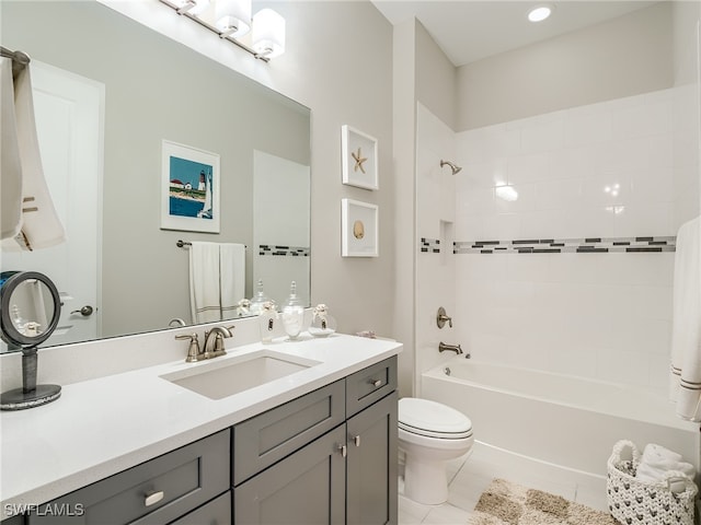 full bathroom with toilet, tiled shower / bath, vanity, and tile patterned flooring