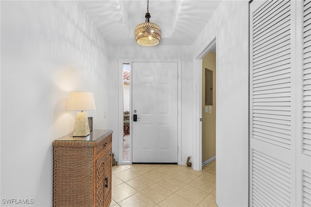 entryway featuring light tile patterned flooring and a chandelier