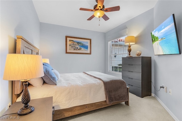 bedroom with light carpet and ceiling fan