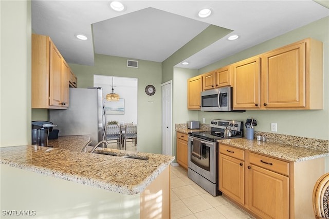 kitchen with kitchen peninsula, stainless steel appliances, sink, light stone countertops, and light tile patterned floors