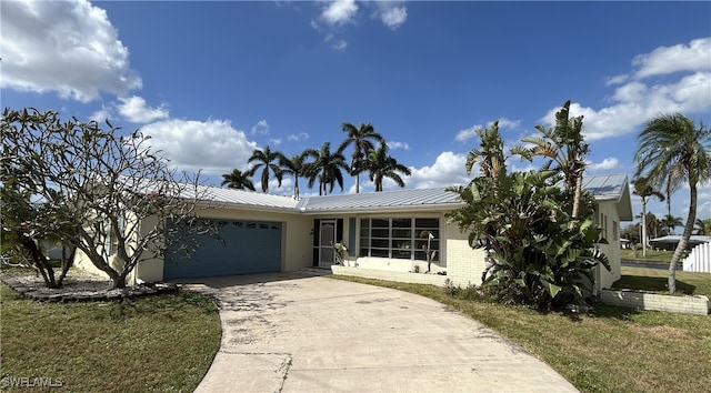 view of front of home with a front lawn and a garage