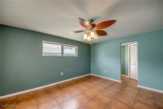 tiled empty room with ceiling fan