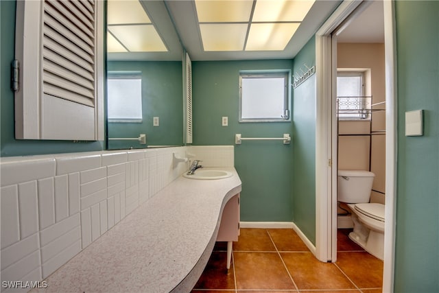 bathroom featuring vanity, decorative backsplash, toilet, and tile patterned flooring