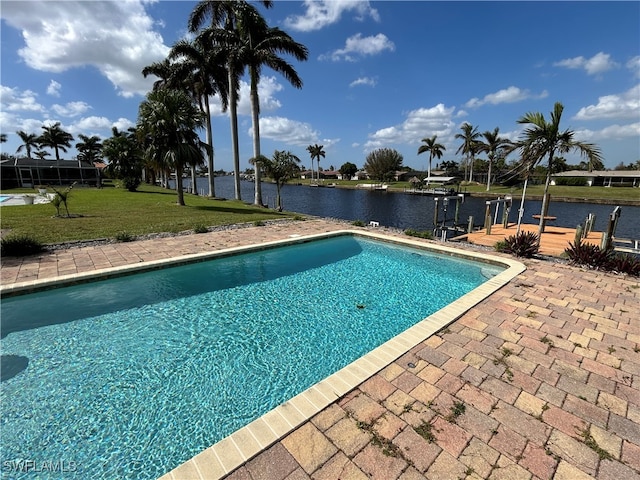 view of pool with a boat dock, a water view, a lawn, and a lanai