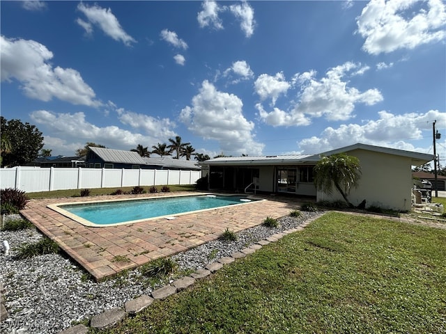 view of pool with a yard and a patio