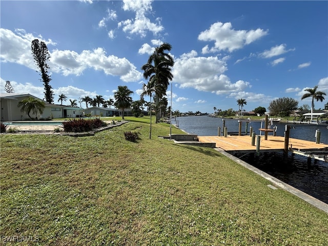 view of yard with a dock and a water view