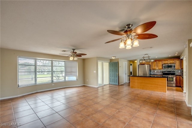 kitchen featuring decorative backsplash, stainless steel appliances, and light tile patterned floors