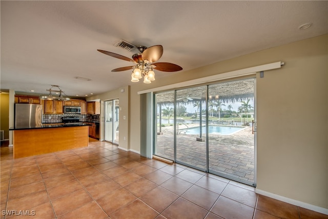 interior space with ceiling fan and light tile patterned floors