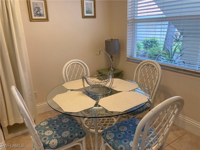 dining space with baseboards and tile patterned floors