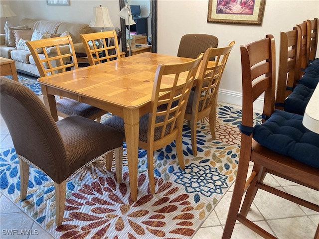 dining room with light tile patterned floors and baseboards