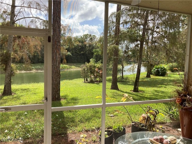 unfurnished sunroom featuring a water view