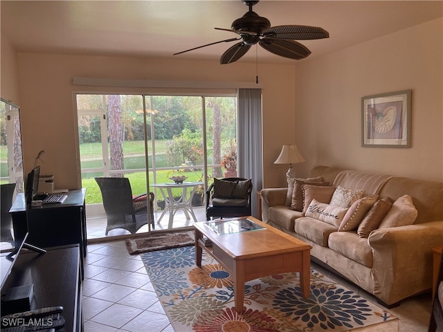 living room featuring light tile patterned floors, ceiling fan, and a wealth of natural light