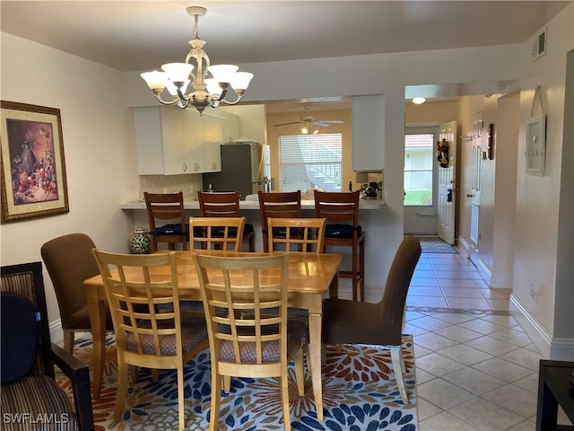 dining area with light tile patterned floors, ceiling fan, visible vents, and baseboards