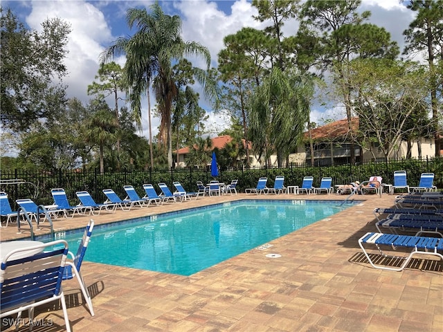 pool with fence and a patio