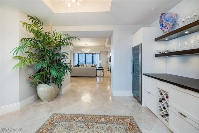 4851 Bonita Bay Blvd Unit 2203, Bonita Springs, FL 34134 - hallway with wine cooler, baseboards, marble finish floor, and a chandelier