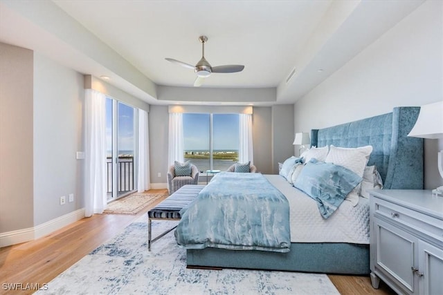 4851 Bonita Bay Blvd Unit 2203, Bonita Springs, FL 34134 - bedroom featuring baseboards, wood finished floors, visible vents, and access to exterior