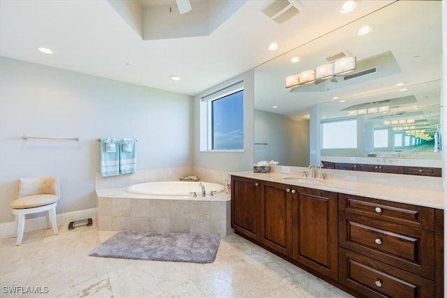 bathroom featuring vanity and tiled tub