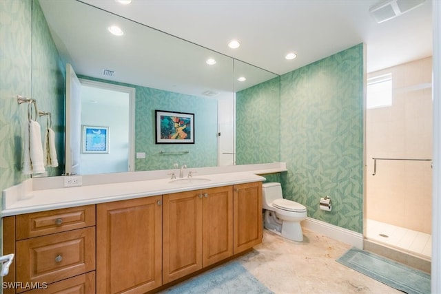 bathroom with walk in shower, vanity, and toilet