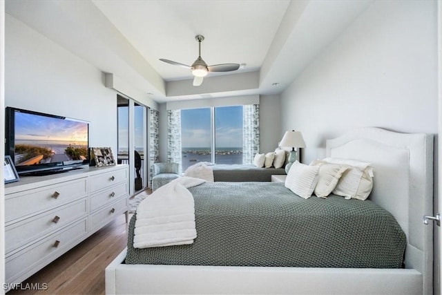 4851 Bonita Bay Blvd Unit 2203, Bonita Springs, FL 34134 - bedroom with dark wood-style flooring, a water view, and ceiling fan